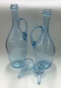 A pair of unusual blue glass ewers with removable