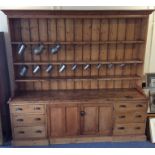 A massive pine kitchen dresser with plank back, de