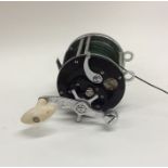 An "Ocean City Big Game" fishing reel. Est. £25 -