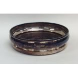 A modern silver wine coaster with mahogany inset b