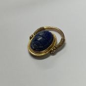 An unusual gold swivel ring in the form of a scara