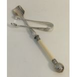 A silver plated stilton scoop together with a pair