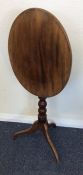 A mahogany tilt top occasional table on spreading