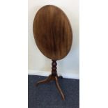A mahogany tilt top occasional table on spreading