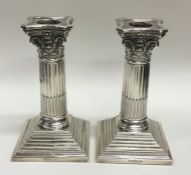 A good pair of Corinthian column silver candlestic