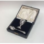 A cased silver egg cup together with matching spoo