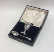 A cased silver egg cup together with matching spoo