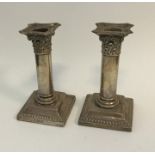 A pair of Edwardian Corinthian column silver candl