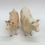 A Beswick model of a bull together with one other.