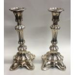 A pair of Continental tall silver candlesticks on