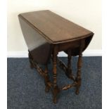 A small oak drop leaf table with twisted stems. Es
