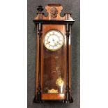A mahogany cased Vienna style wall clock with whit