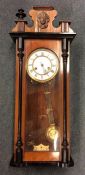 A mahogany cased Vienna style wall clock with whit