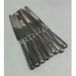 A matched set of eight silver knives with reeded d