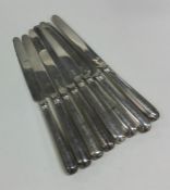 A matched set of eight silver knives with reeded d