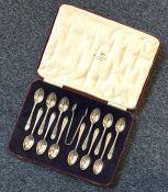 A heavy set of twelve silver teaspoons and tongs i