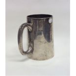 A heavy silver tapering pint mug with gilt interio