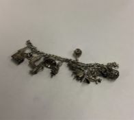 A heavy silver curb link charm bracelet. Approx. 7