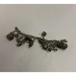 A heavy silver curb link charm bracelet. Approx. 7