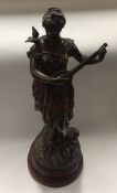 A tall spelter figure of a lady paying a musical i