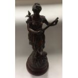 A tall spelter figure of a lady paying a musical i