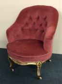 A button back nursing chair in pink upholstery wit