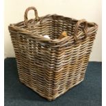 An old wicker two handled log basket. Est. £25 - £
