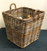 An old wicker two handled log basket. Est. £25 - £