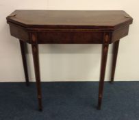 A Georgian mahogany card table with string inlay.