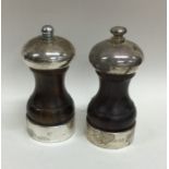 A matched pair of mahogany and silver mounted pepp