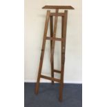 An unusual tall oak picture stand complete with pe