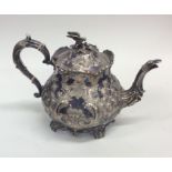 A Britannia Metal teapot embossed with flowers adn