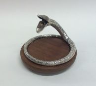 An unusual silver cigar cutter in the form of an e