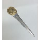 A heavy cast silver and silver gilt letter opener.