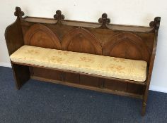 A stained pine church pew. Est. £60 - £80.