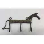 An Antique brass coat hanger in the form of a hors