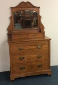 A satinwood dressing chest on bracket feet with ca