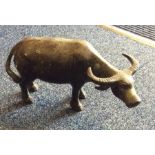 An Antique bronze model of an ox with textured ta