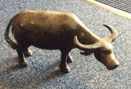 An Antique bronze model of an ox with textured ta