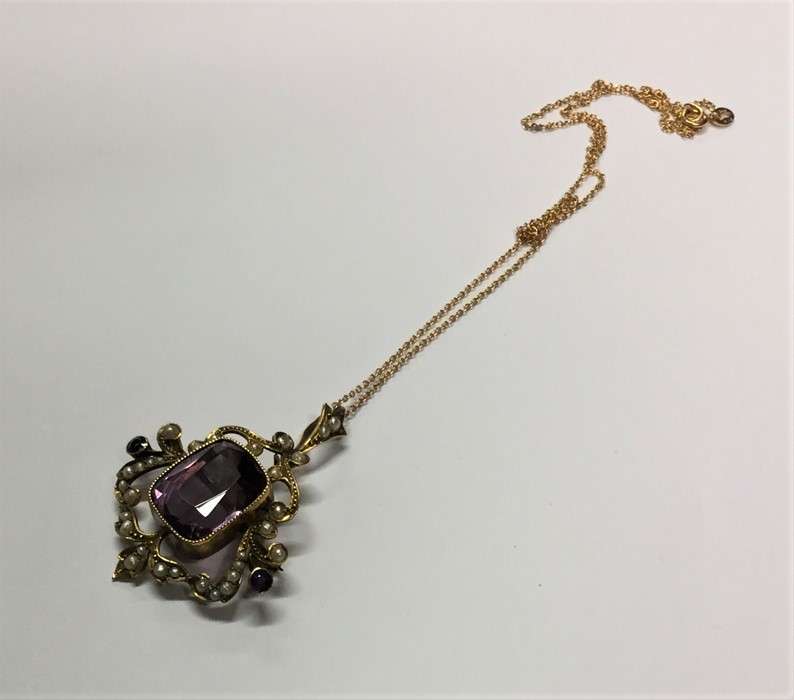 An amethyst and pearl pendant on fine link chain.