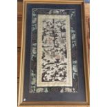 A framed and glazed sampler of Oriental design. Ap