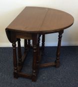 A Georgian oak drop leaf table. Est. £30 - £50.