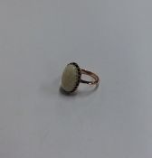 An opal single stone ring in gold claw mount. Appr