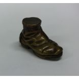 A novelty brass vesta case in the form of a shoe.