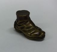 A novelty brass vesta case in the form of a shoe.