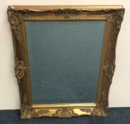 A gilt framed bevel edged wall mirror. Approx. 81