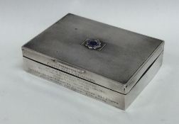 A silver cigarette box presented to Capt R G Leona