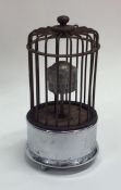 An unusual birdcage mounted as a clock on chrome b