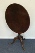 A Georgian mahogany tilt top table on three spread