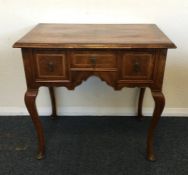 An Antique mahogany and walnut lowboy with three d